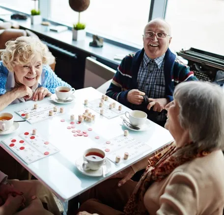 Elderly residents enjoying social activities and games at senior living community