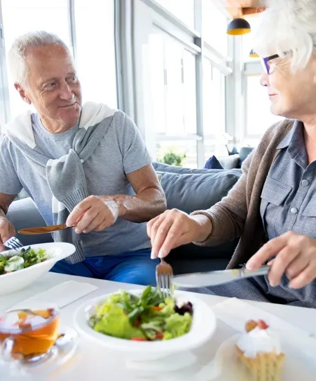 Senior residents enjoying healthy dining and social time at a senior care community
