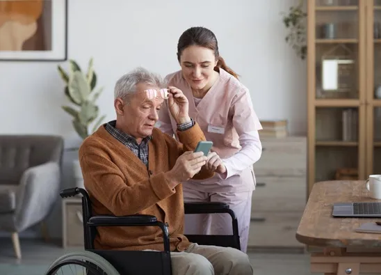 Caregiver assisting senior resident with personal care at Hart Heritage Estates assisted living in Maryland